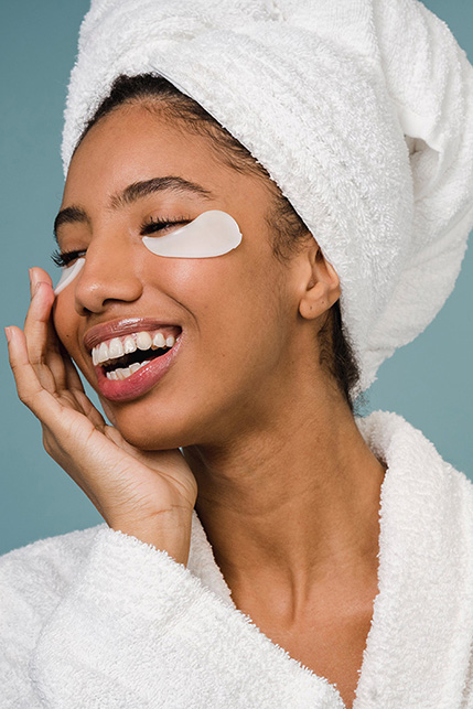 Happy client with under-eye patches during skincare service at Madre Health and Beauty Waxing Boutique, Centennial.